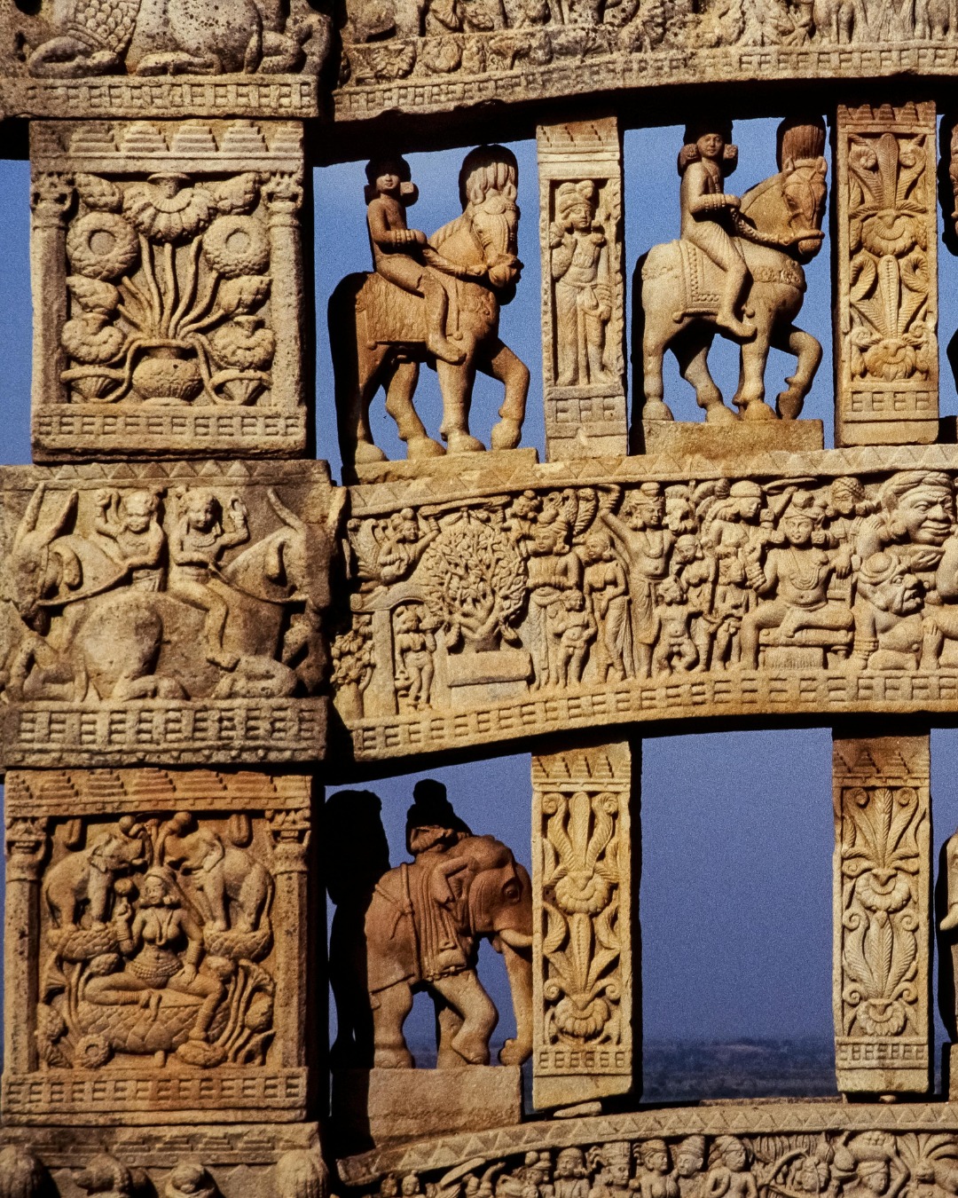 On a hill in Madhya Pradesh, Sanchi's Great Stupa and its intricately carved gateways represent Buddhist art from the 3rd century BCE onwards – among India's oldest stone sculptures, where narrative reliefs tell stories of Buddha's life and Jataka tales with extraordinary detail and artistic sophistication.
Emperor Ashoka commissioned the original stupa in the 3rd century BCE, though the magnificent gateways (toranas) were added later in the 1st century BCE. The stupa itself is simple – a massive hemispherical dome representing Buddha's presence, surrounded by a stone railing with four elaborately carved gateways facing cardinal directions.
These gateways hold Sanchi's artistic genius. Carved from sandstone, they're covered in relief sculptures depicting Buddha's previous lives, his path to enlightenment, and early Buddhist symbols. Interestingly, Buddha himself isn't shown in human form – early Buddhist art represented him through symbols: the Bodhi tree, footprints, an empty throne, or the dharma wheel. This symbolic representation rather than direct depiction creates narrative requiring viewers to interpret.
The carvings show remarkable detail – elephants, horses, humans in various activities, trees, architectural elements, all rendered with naturalism and artistic confidence. The yakshi (female figure) bracket figures supporting gateway architraves are particularly celebrated – sensuous, graceful sculptures that influenced Indian art for centuries.
Sanchi survived because it was abandoned and forgotten, rediscovered only in 1818. This isolation protected what war or religious change destroyed elsewhere – giving us one of the most complete early Buddhist artistic sites surviving anywhere.
Sanchi represents Indian sculpture at its beginning – the artistic vocabulary being established that would evolve for two millennia.
#EnrichingJourneys
#TravelWithEJ
#Sanchi #SanchiStupa #MadhyaPradesh #BuddhistArt #BuddhistSculpture #AncientIndia #SculpturalMasterpieces #AshokanEra #UNESCOWorldHeritage #India #IndiaTravel #TravelIndia #ExploreIndia #IncredibleIndia #BuddhistHeritage #IndianHeritage #CulturalHeritage #IndianArt #BuddhistMonuments